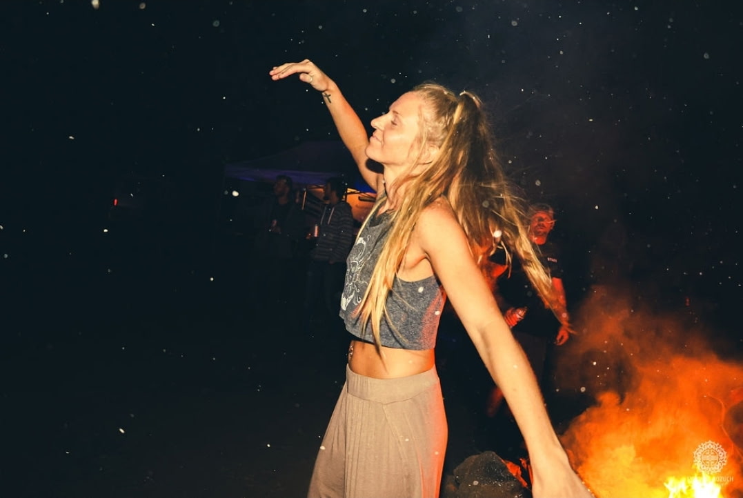 Dancing by the bonfire at a farm gathering